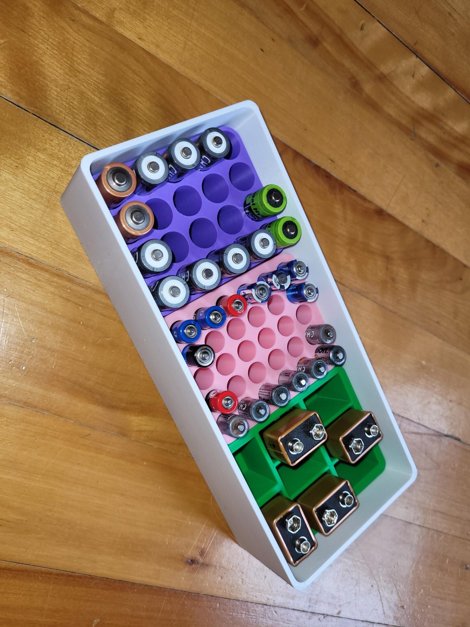 Button cell holder tray for LR44 and CR coin cell batteries