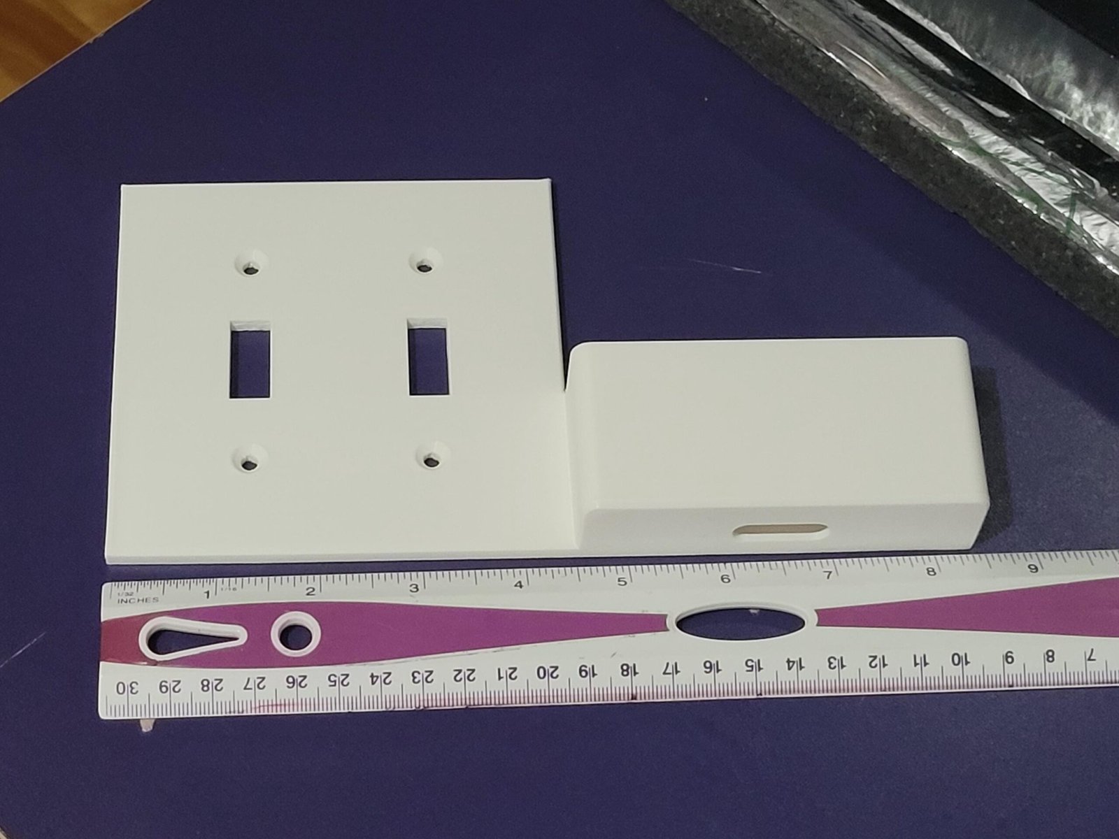 Angled view of the double switch plate phone charging dock