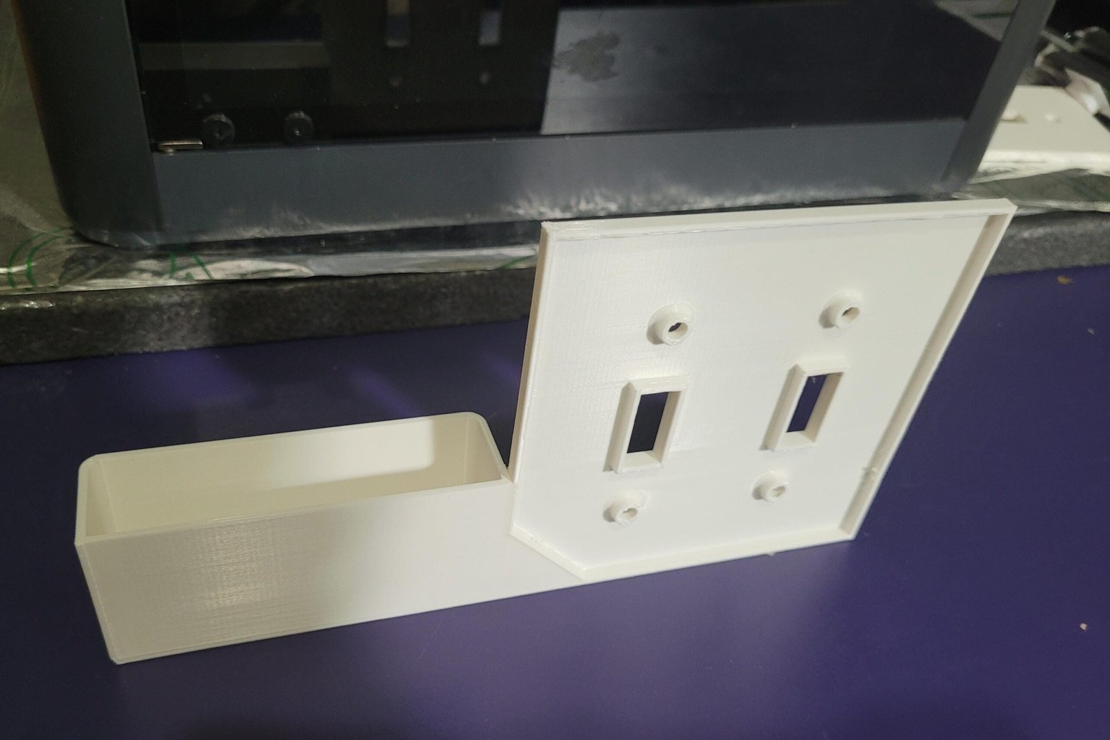 Double switch plate phone holder painted to match wall colour