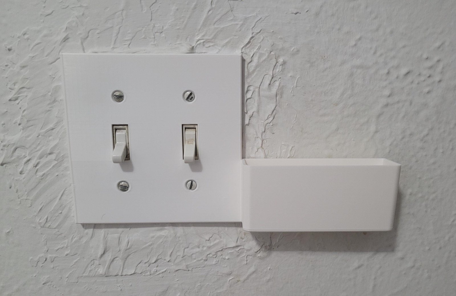 3D printed double switch plate phone holder part