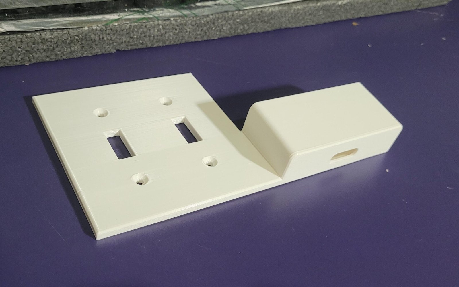 Side view of the double switch plate phone holder