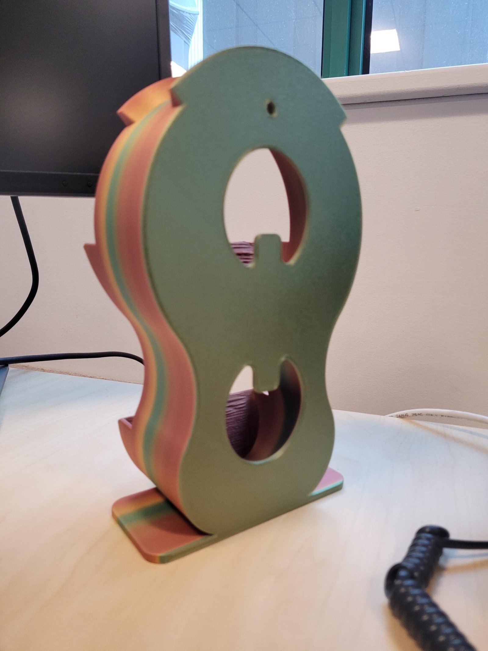 Angled view of the copper and green headphone holder