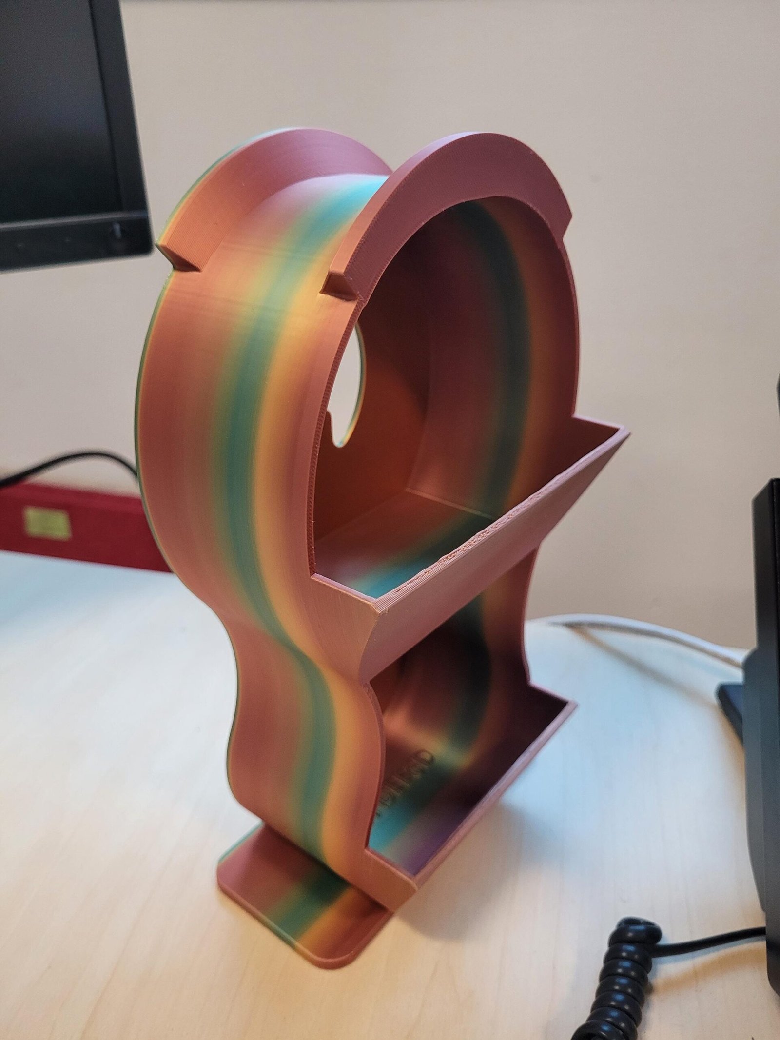 Metallic finish headphone holder on a desk