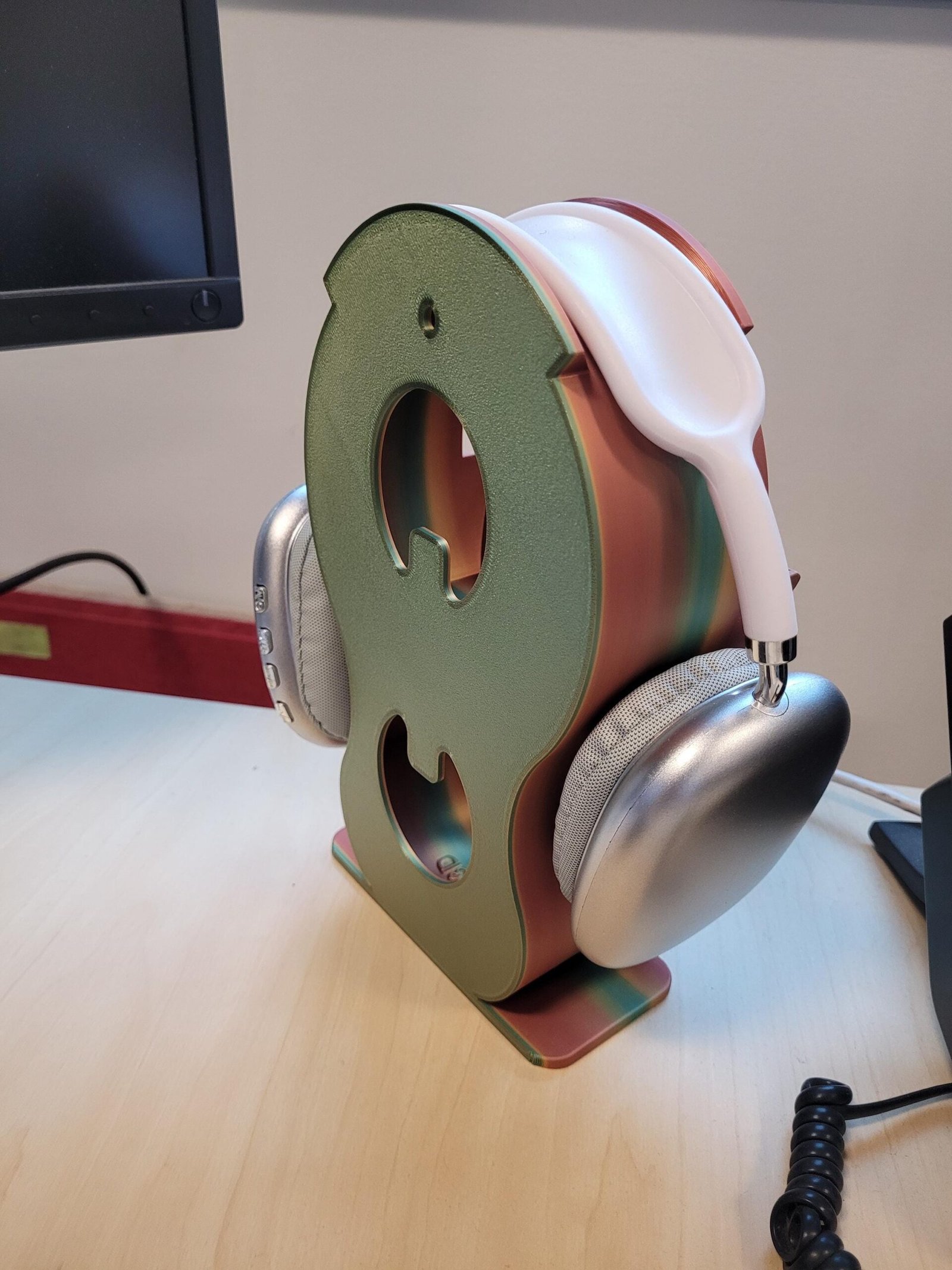 Metallic headphone holder in a desk setup