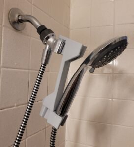 Close-up of the 3D printed shower head height adjuster hook mechanism