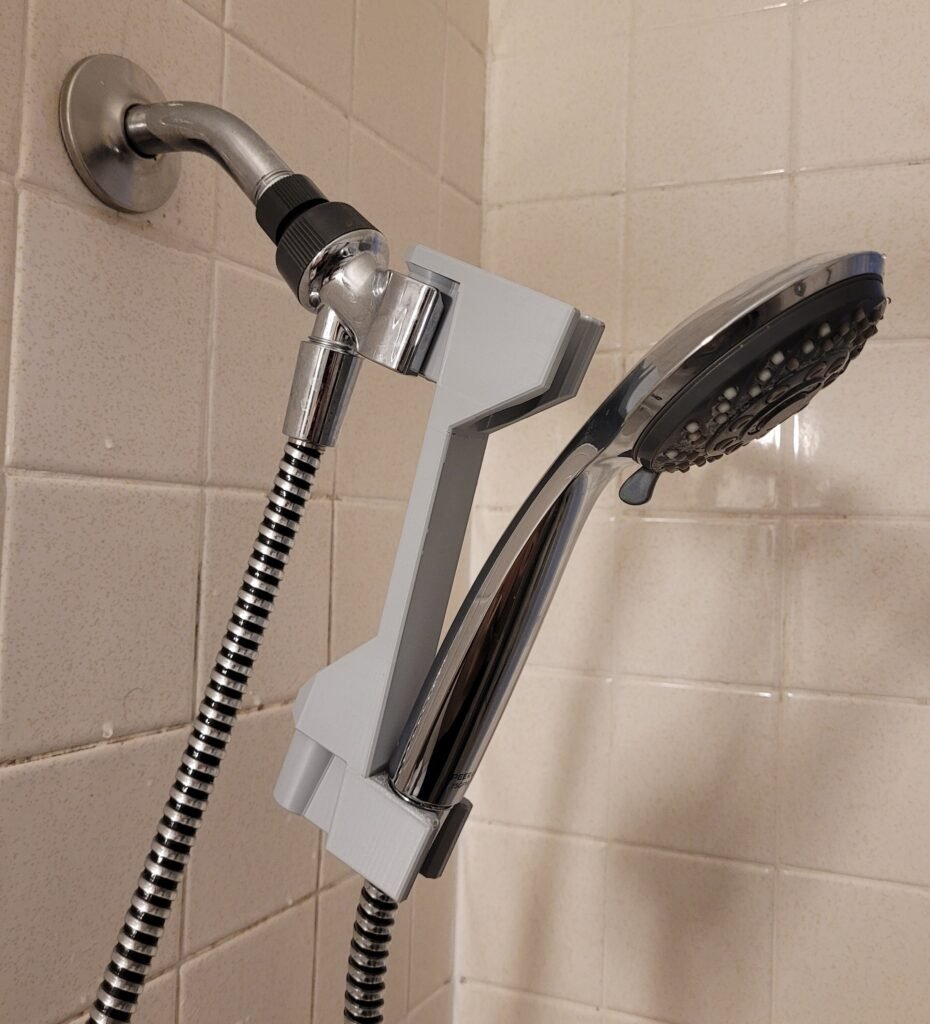 Close-up of the 3D printed shower head height adjuster hook mechanism