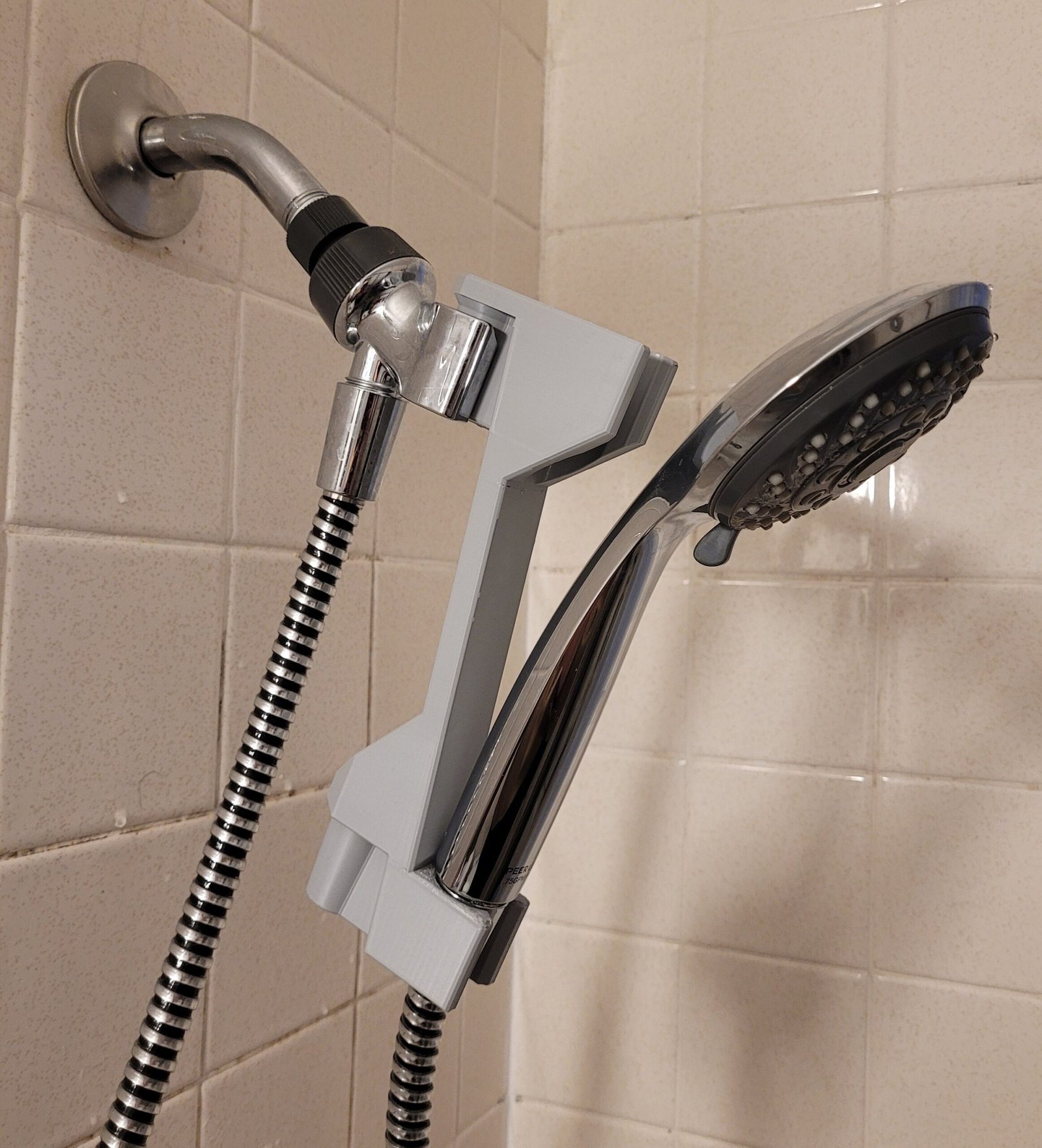 Close-up of the 3D printed shower head height adjuster hook mechanism