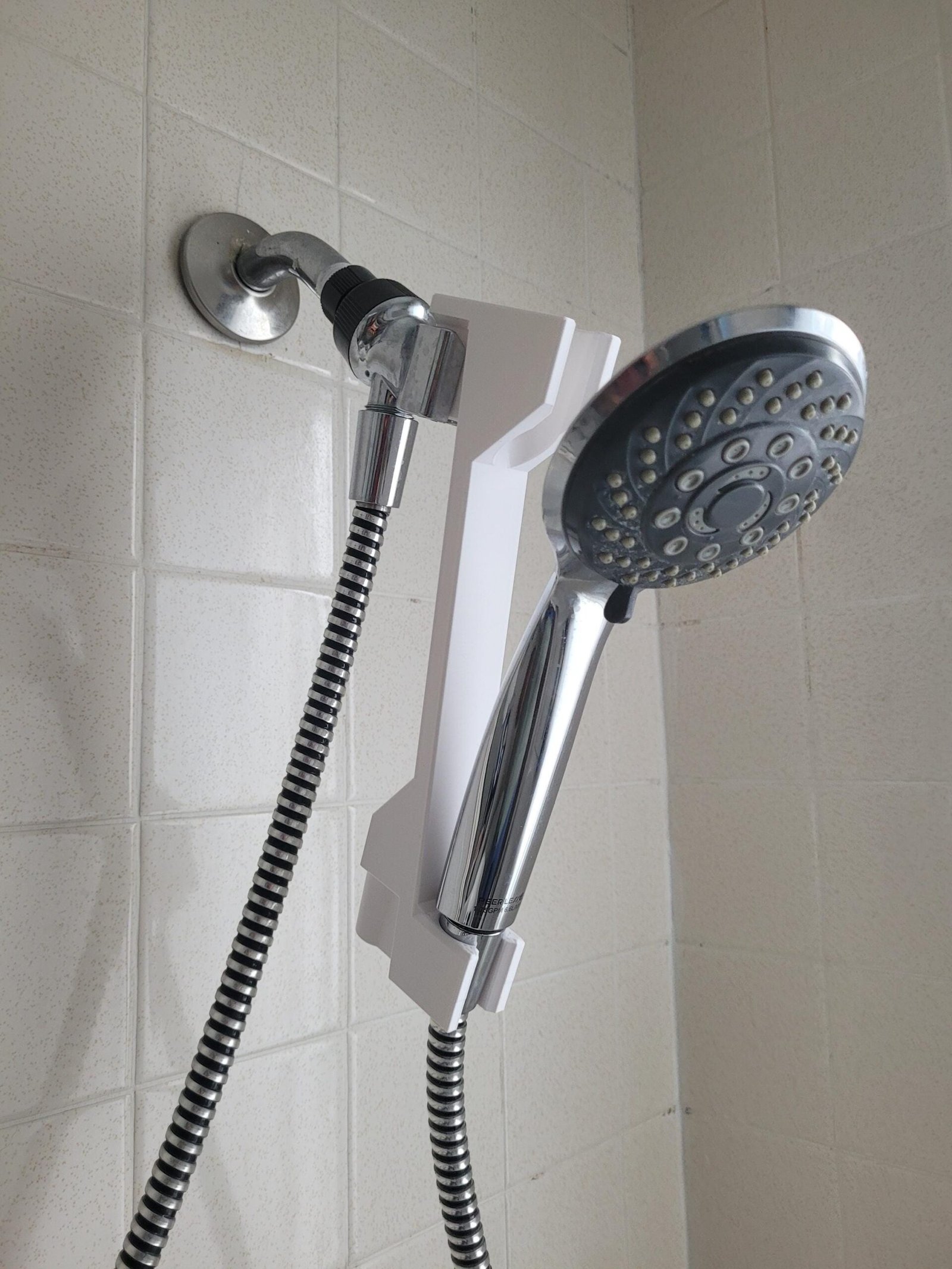 Detail view of the white shower head adjuster mechanism