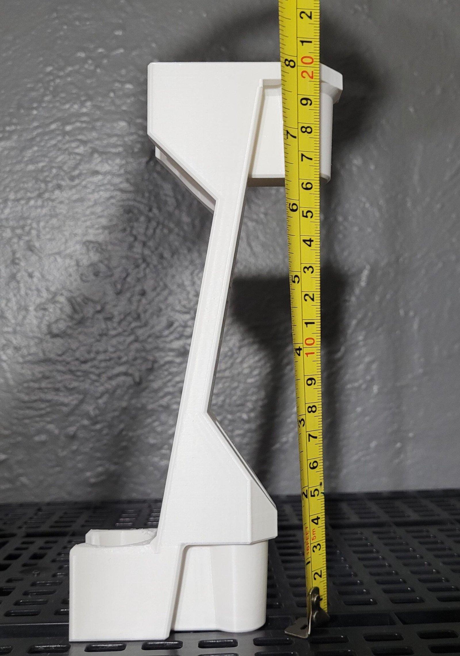 White shower head height adjuster in a bathroom setting