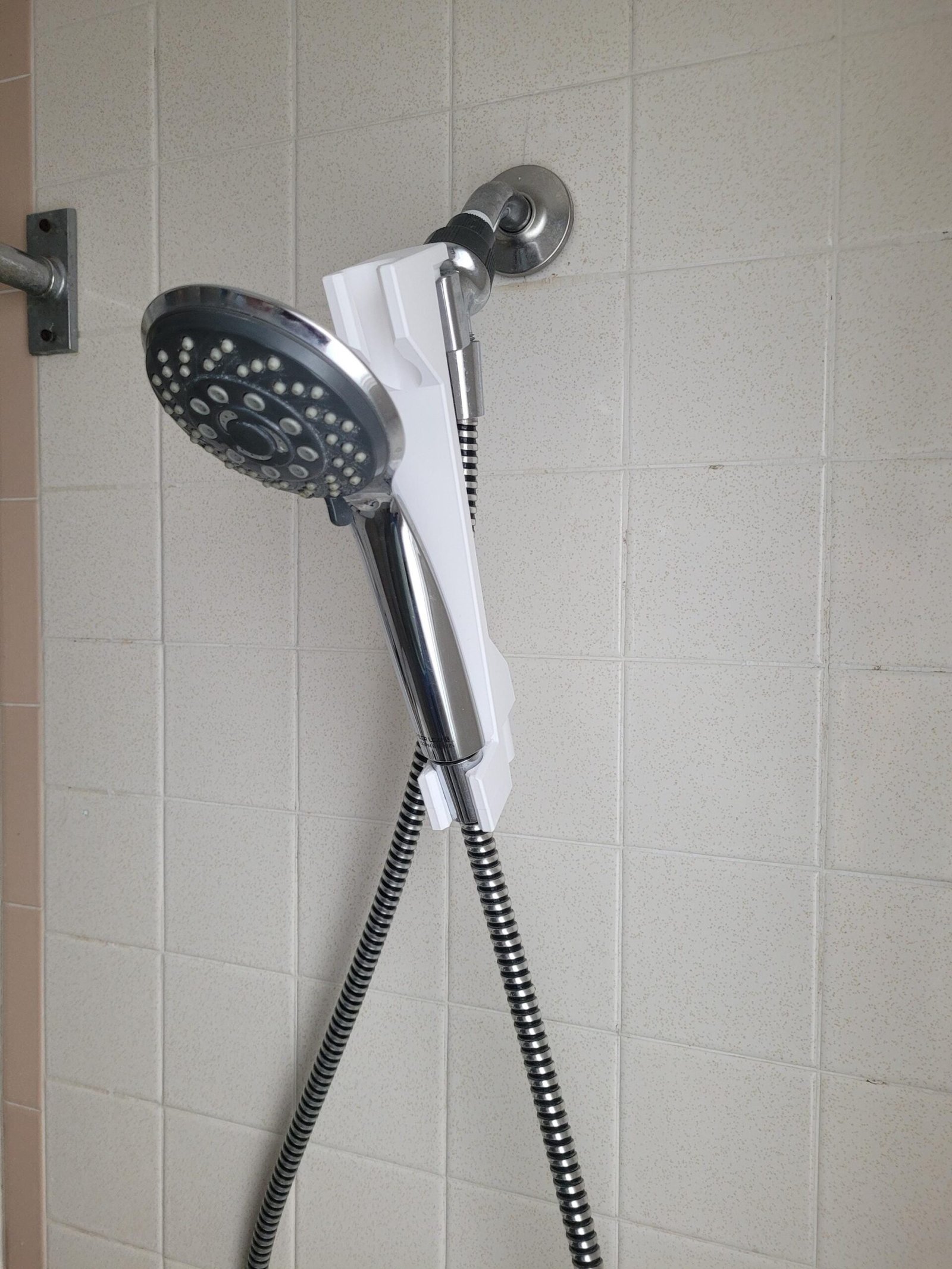 White shower head adjuster used at normal height