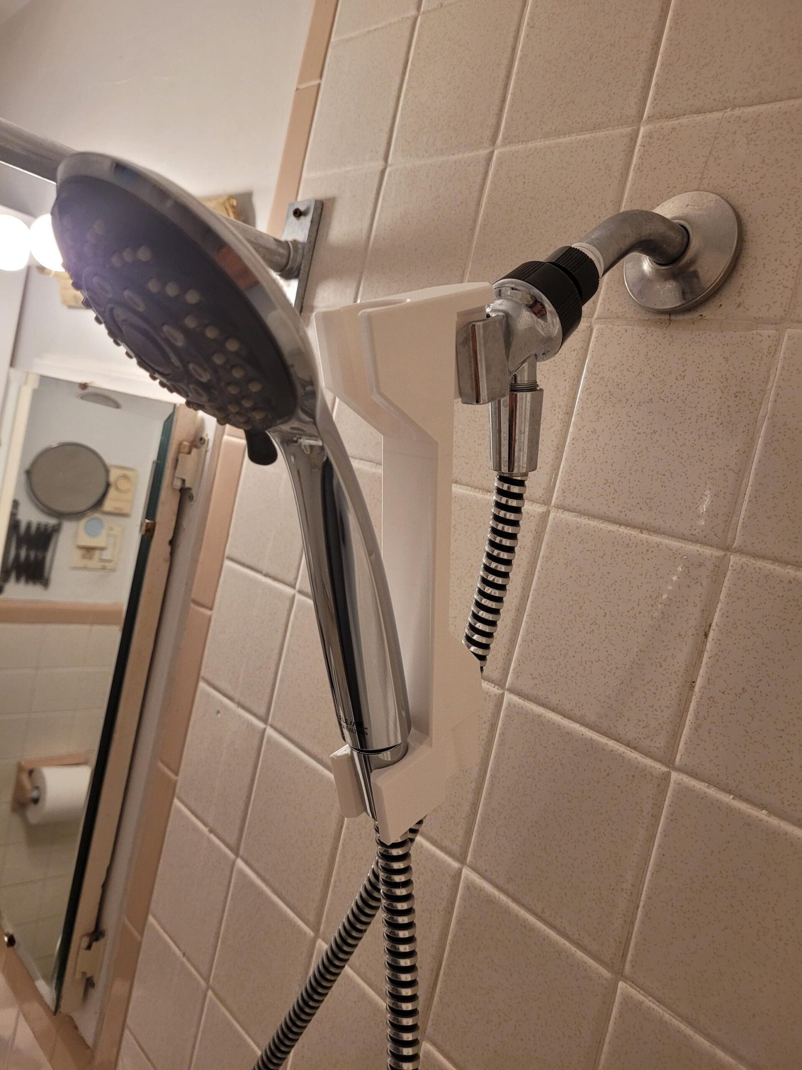 White shower head adjuster set to the upper position