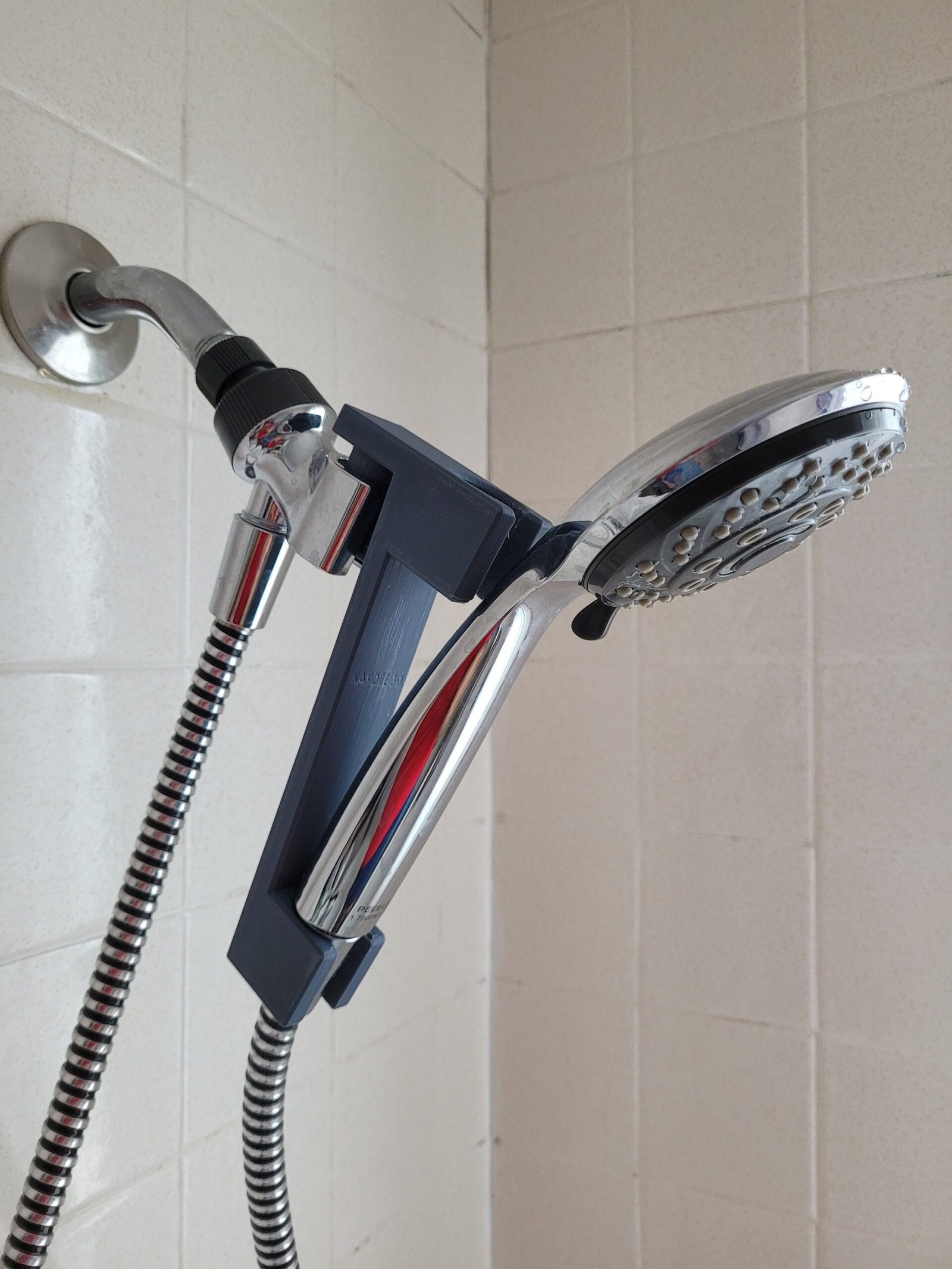 Shower head lowering extension installed on a handheld shower