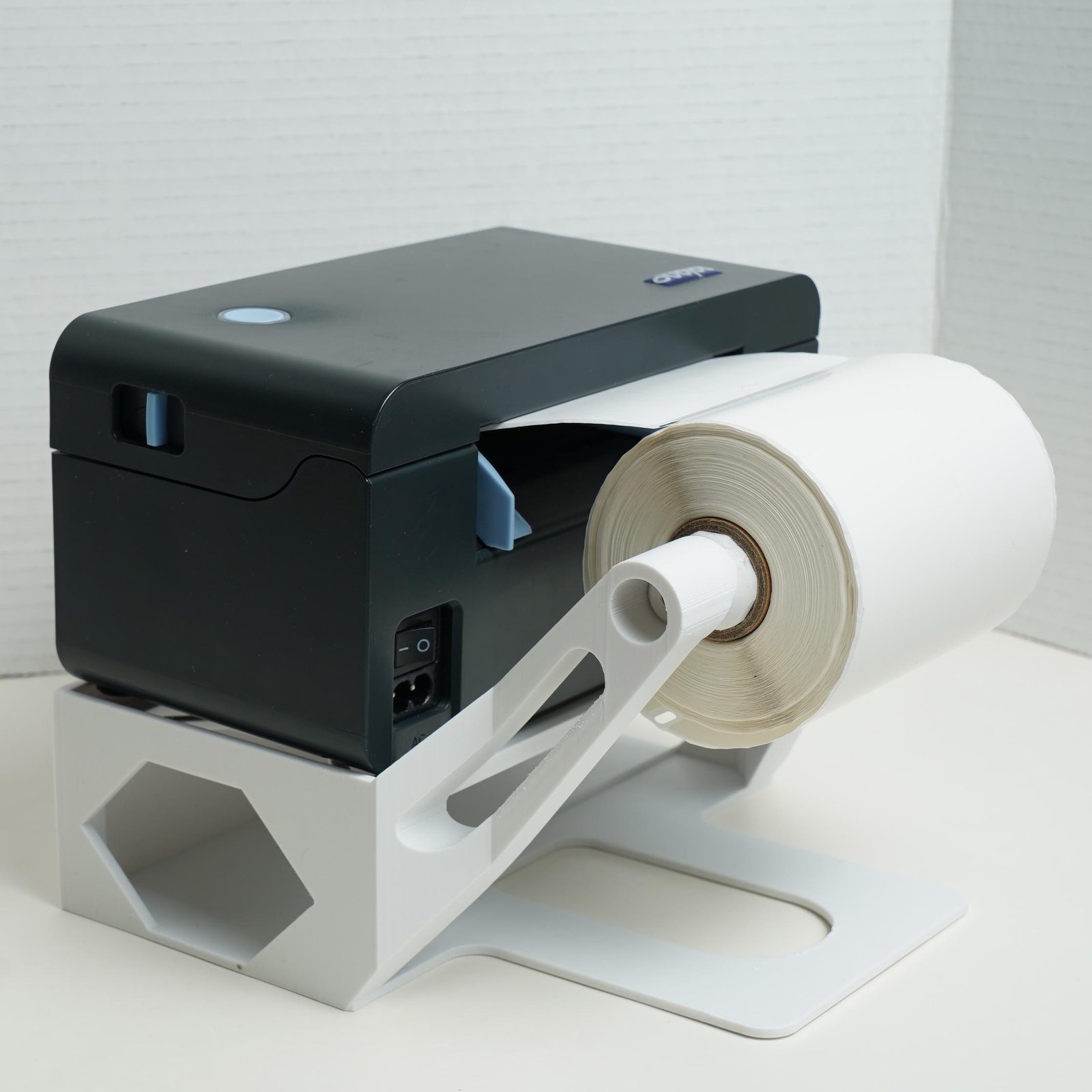 Label roll holder on the thermal label printer stand
