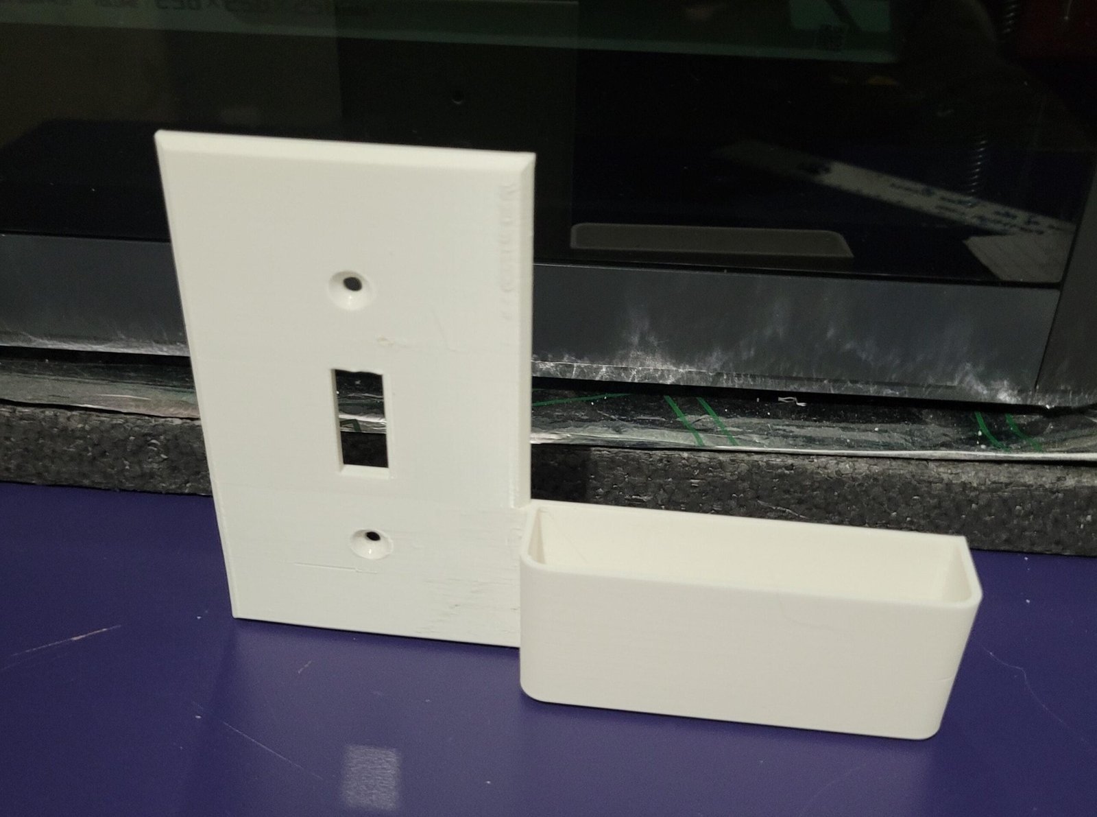Left-hand printed part of the wall switch plate phone holder