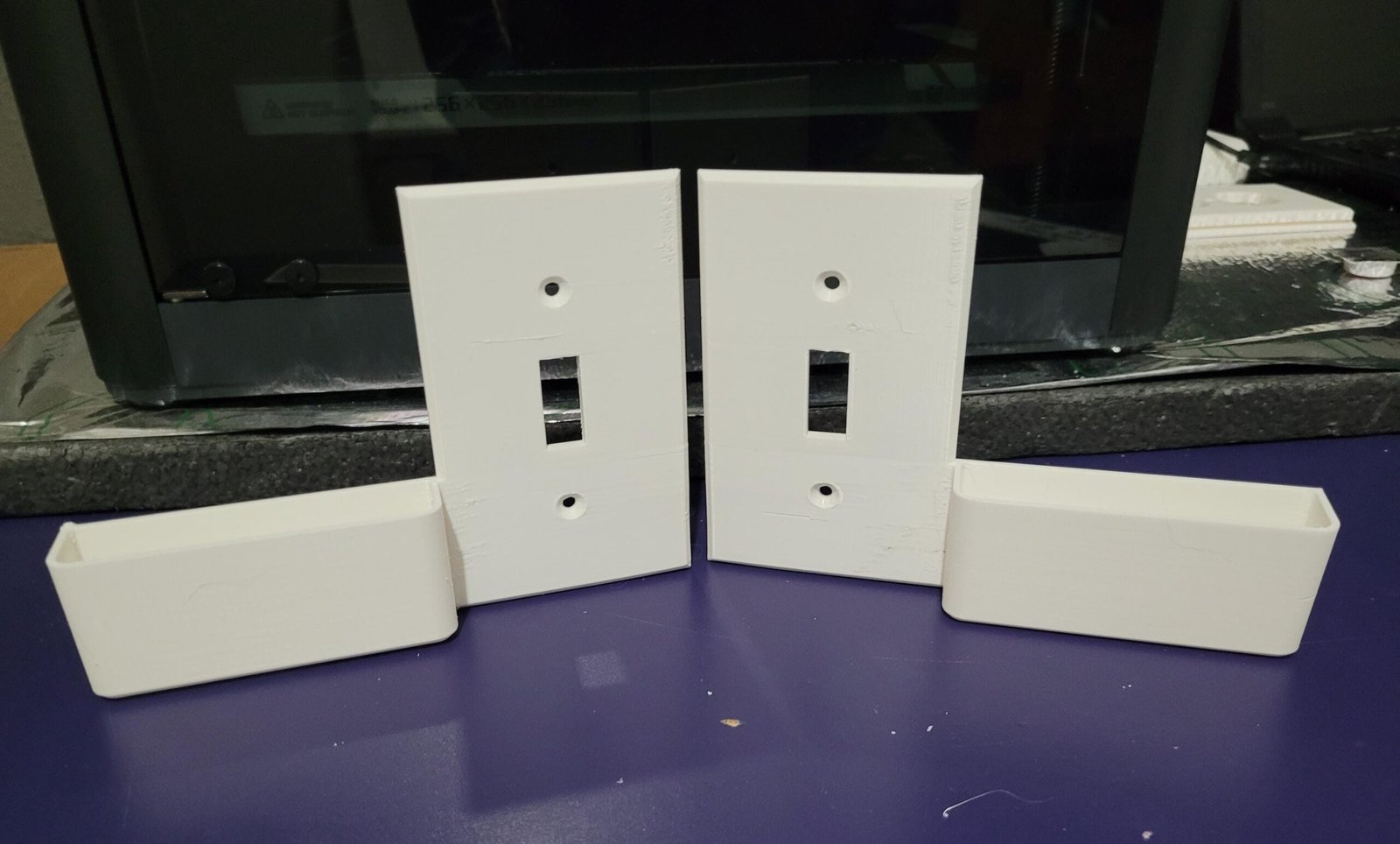 Wall switch plate phone holder painted to match wall colour