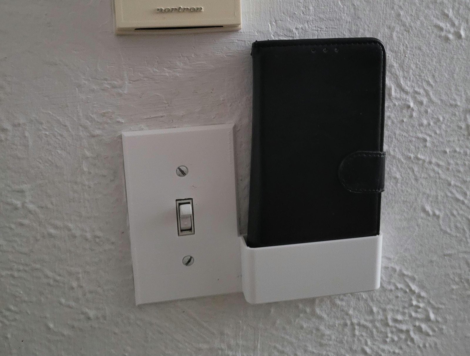 3D render of the wall switch plate phone holder design