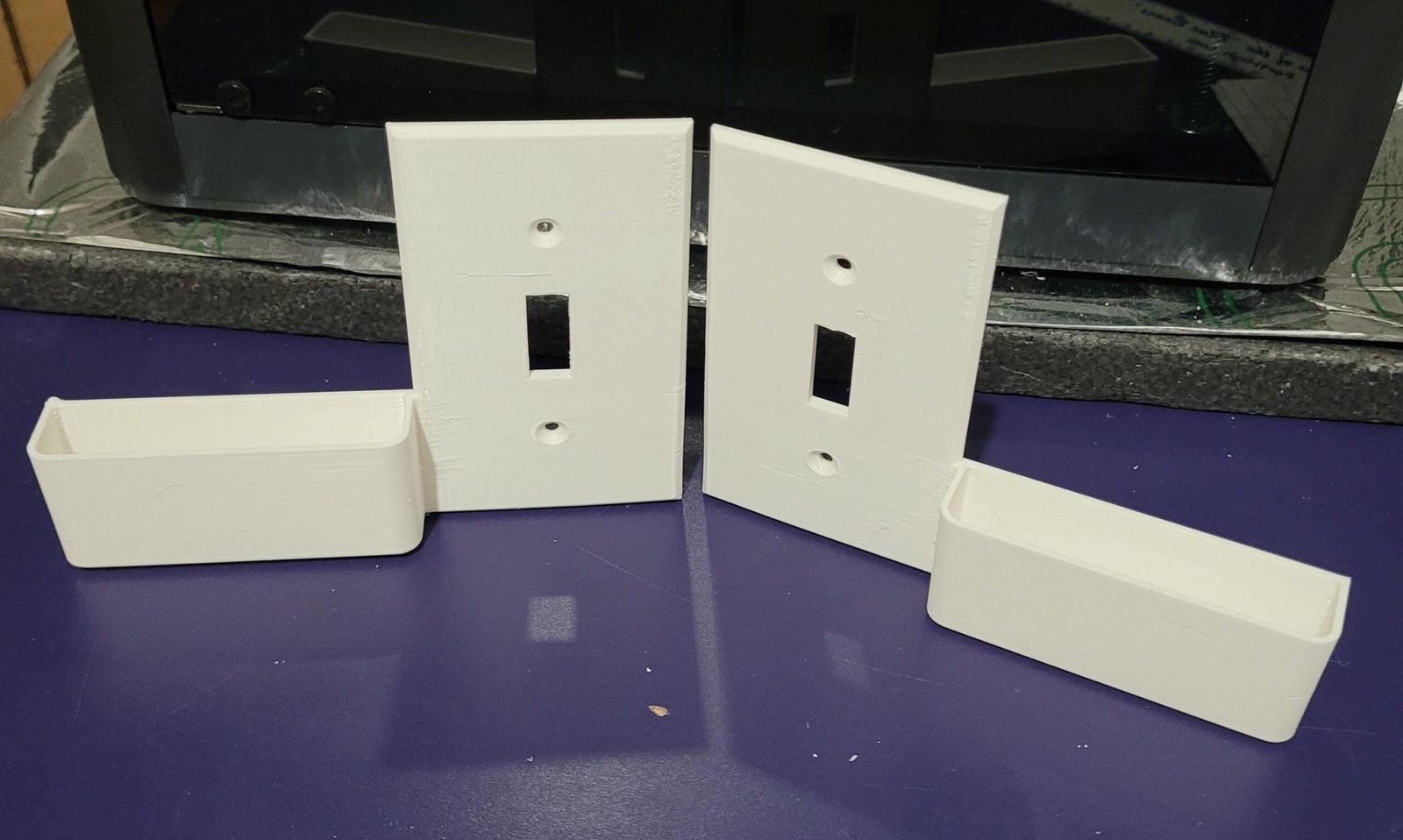 Wall switch plate phone holder holding a phone
